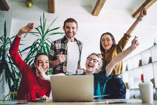 Cheerful friends celebrating homework fulfillment