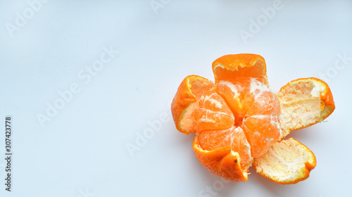 peeled tangerine on a white background.Orange fruits and peeled segment Isolated. Pile of orange segments