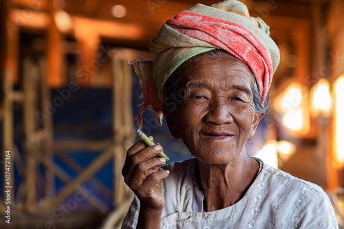 Portrait of Happy Old Burmese Lady Smoking a Cigar at Indein Village Near Inle Lake, Shan State, Myanmar (Burma)