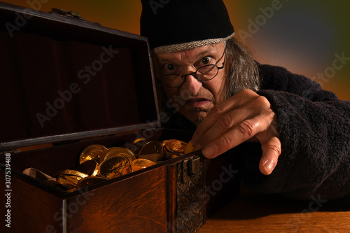 Old Scrooge making sure his gold coins are safe