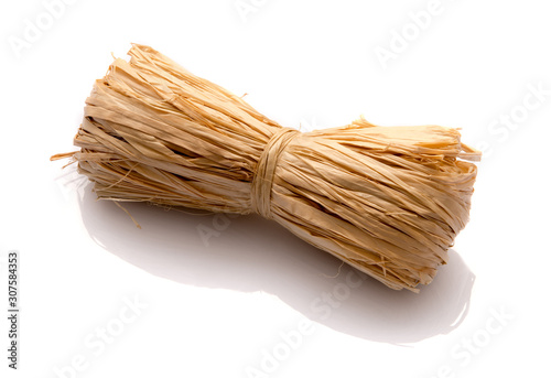 Roll of natural raffia on a white background