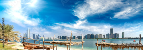 Panoramic view of Abu Dhabi Downtown skyline from the beach at sunset, UAE