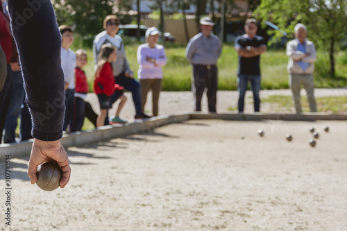 Senior people playing bocce in a park