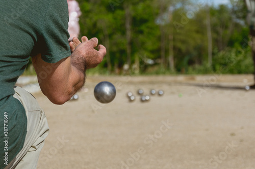 Senior people playing bocce in a park