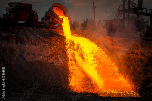 Discharge of metallurgical slag from blast furnaces. Beautiful stream of hot slag