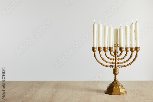 burning candles in menorah on Hanukkah isolated on white