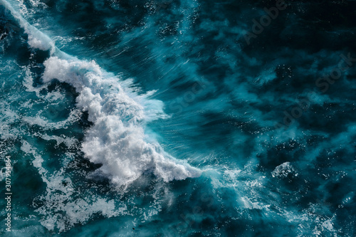 Aerial view to waves in ocean Splashing Waves. Blue clean wavy sea water. Bali, Indonesia.