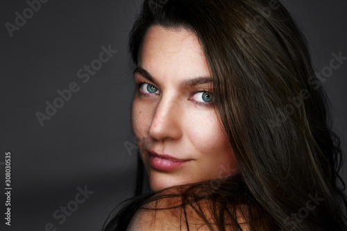 Portrait of pretty woman dark hair, blue eyes.