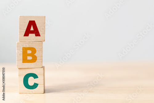 ABC letters alphabet on wooden cube blocks in pillar form on wood table