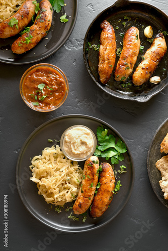 Grilled sausages with sauerkraut and sauce