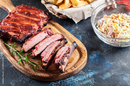 Spicy barbecued pork ribs served with BBQ sauce