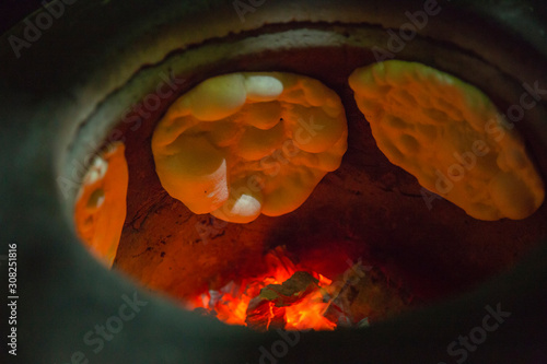 Naan Bread and flame on the hot oven