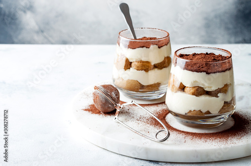 Traditional Italian dessert tiramisu in a glass.