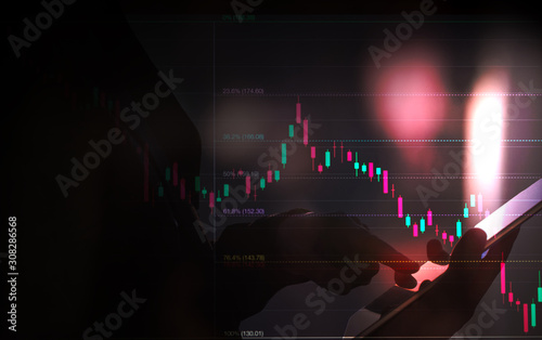 business man or stock trader analyzing stock graph chart by fibonacci indicator, business man holding tablet for buy or sell, double exposure stock graph and person, market graph analysis concept