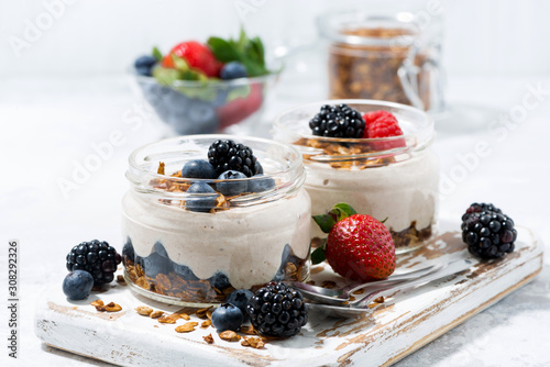 healthy creamy dessert with fresh berries on white background