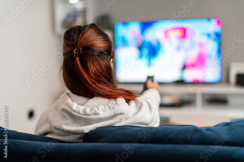 Girl watching tv programs on the sofa