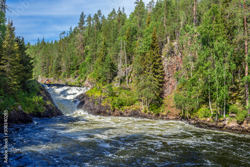 The flow of Yattumutka river and the waterfall at Jyrava view point in Oulanka National Park. Pieni Karhunkierros Trail in Finland.
