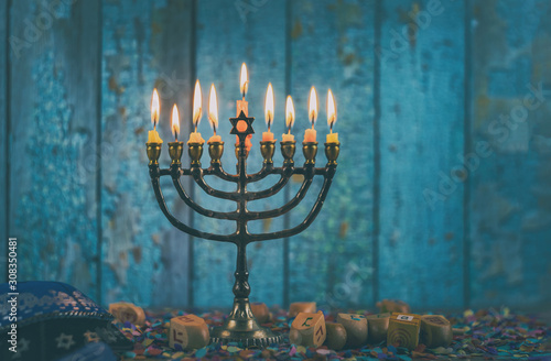 Closeup of a burning Chanukah candlestick with candles Menorah