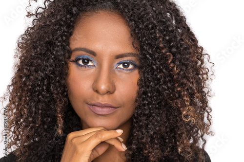 closeup of curly hair african american woman looking confident at camera with serious expression. Isolated on white background.