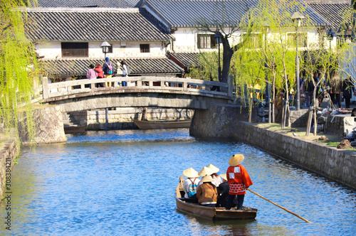 People in old-fashioned boat, Kurashiki city, Japan