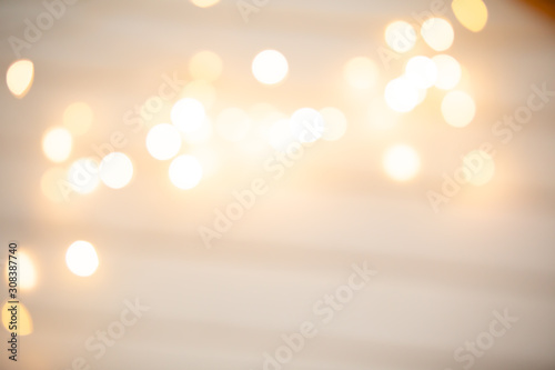 Glitter vintage lights background, golden and beige colors. Image defocused.
