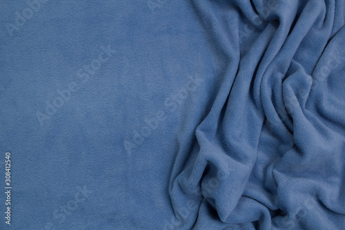 Fleece fabric blue top view. Texture of textile fleece bedspread.