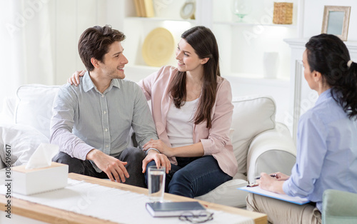 Happy couple cuddling and telling good words at marital session