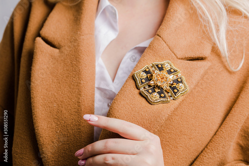 Beautiful brooch in the shape of medal, close-up