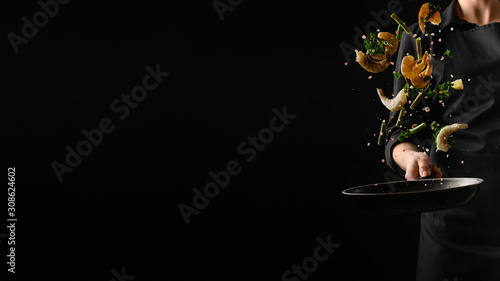 Seafood, frying shrimp with vegetables, a chef on a black background. Advertising banner for the sale of seafood, on a black background for design
