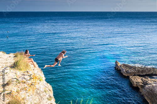 Croatia, Istria, Pula, Cape Kamenjak, man jumping from a cliff