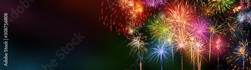 Colorful fireworks with wide dark copy space