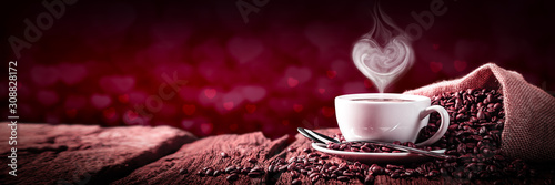  Coffee With Heart Shaped Steam On Old Weathered Table And Red Heart Bokeh Background - Valentine's Day Concept 
