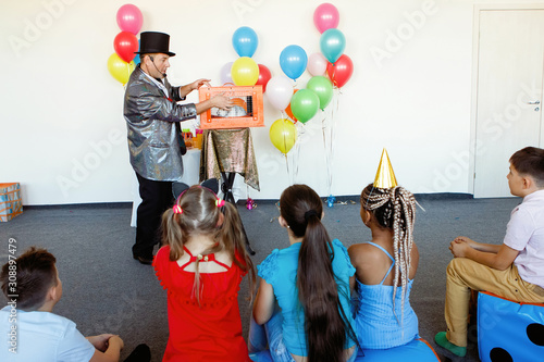 Magician, an illusionist shows tricks.