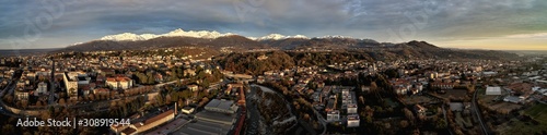 Aerial view of the city of Biella, with snow on the mountains