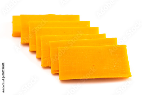 Rectangle Slices of Sharp Cheddar Cheese on a White Background