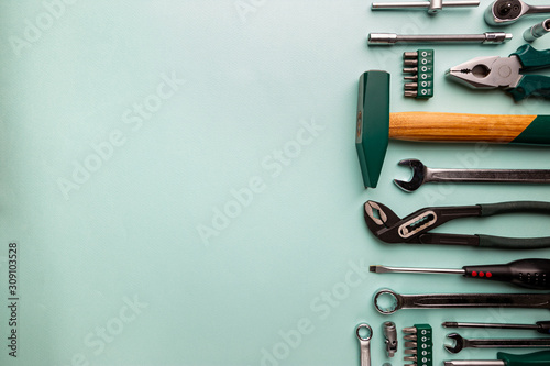 Set of tools over blue background, top view with space for text