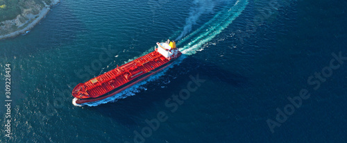 Aerial drone ultra wide panoramic photo of industrial crude oil tanker cruising open ocean deep blue sea