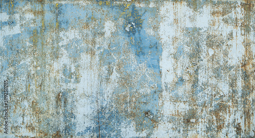 Painted in blue metal rusted background. Metal rust texture. Erosion metal. Scratched and dirty texture on outdoor rusted metal wall.