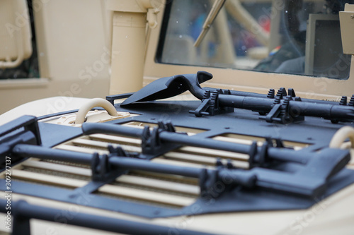  Tools mounted on the hood of a Humvee military vehicle - hammer, axe, shovel and pickaxe.
