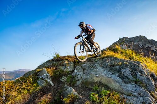 A man is riding enduro bicycle.