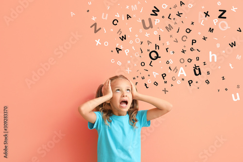 Surprised little girl on color background