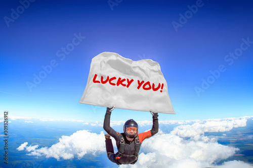 Lucky you. Flag in skydiving. People in free fall.Teampleat skydiver. Extreme sport.