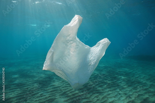 A white plastic bag adrift underwater pollution in the ocean