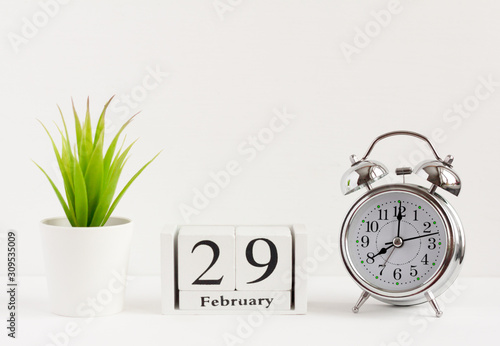 February 29 on a wooden calendar next to the alarm clock.Calendar date, holiday event or birthday.The last day of the winter month. February 29 happens every four years.