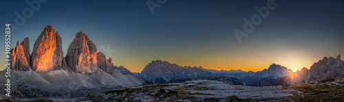 Panorama of Tre Cime peaks in Dolomites at sunset, Italy
