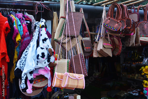 Close up of a shop displaying varieties of handicraft local goods like bags, shawls in Elephant falls of Shillong for sale, selective focusing