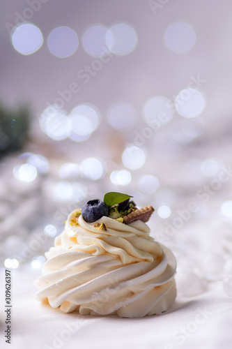 Pavlova's cake. Marshmallows meringue white cream Christmas background bokeh appetizing sweet treats gift home baking pastry shop