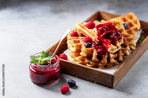 Homemade sourdough waffles with berry sauce for breakfast. The concept of proper nutrition. Selective focus, copy space.