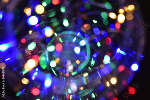 Abstract christmas background with bokeh defocused lights decoration. Colorful lights on black background.