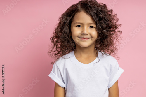 Portrait of a pretty curly little girl
